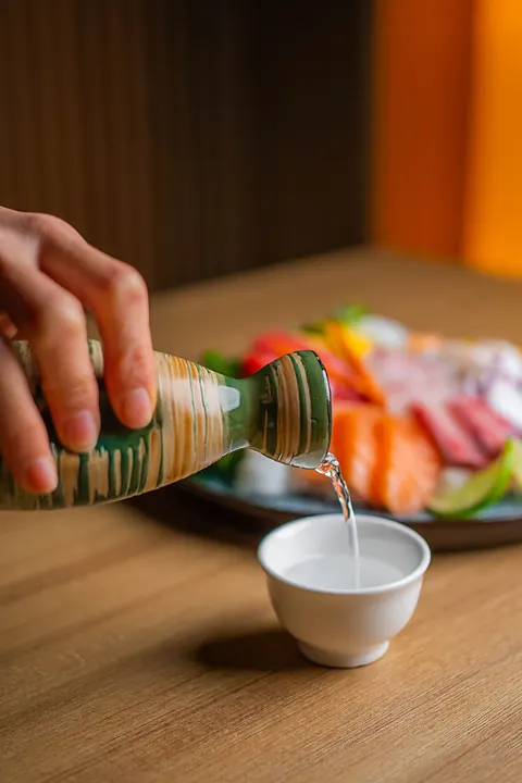 Pouring sake into a small cup