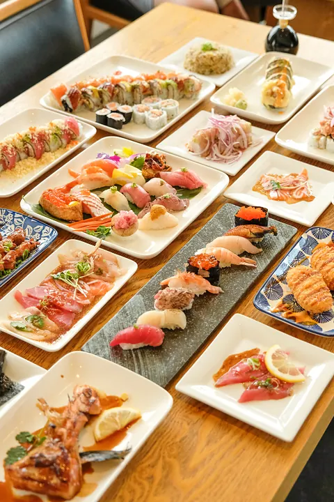 A full table of sushi and small plates from above
