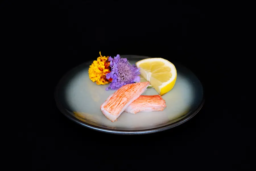 Nigiri with a lemon wedge and flowers