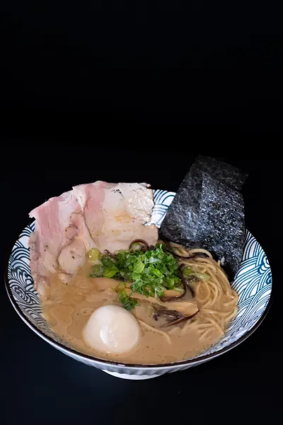 A bowl of ramen in a pale broth