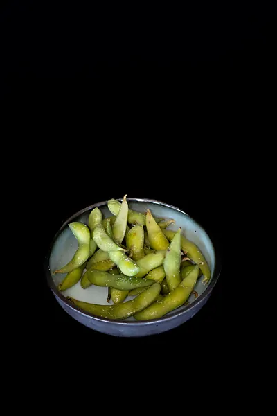 A small bowl of green soybean pods