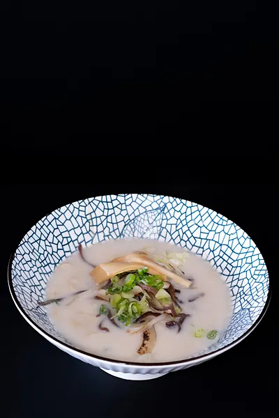 A bowl of creamy soup with greens
