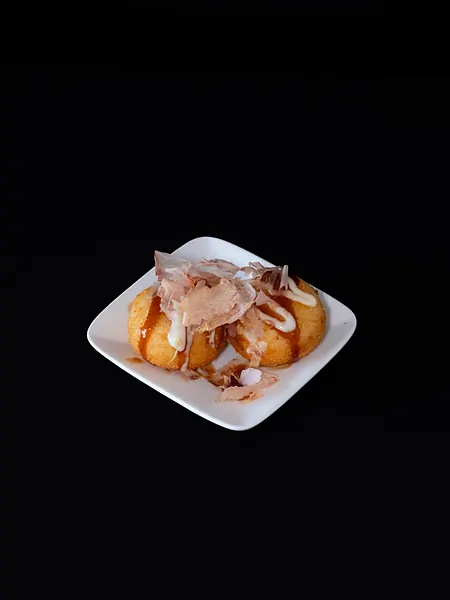 Fried bites with toppings on a small plate