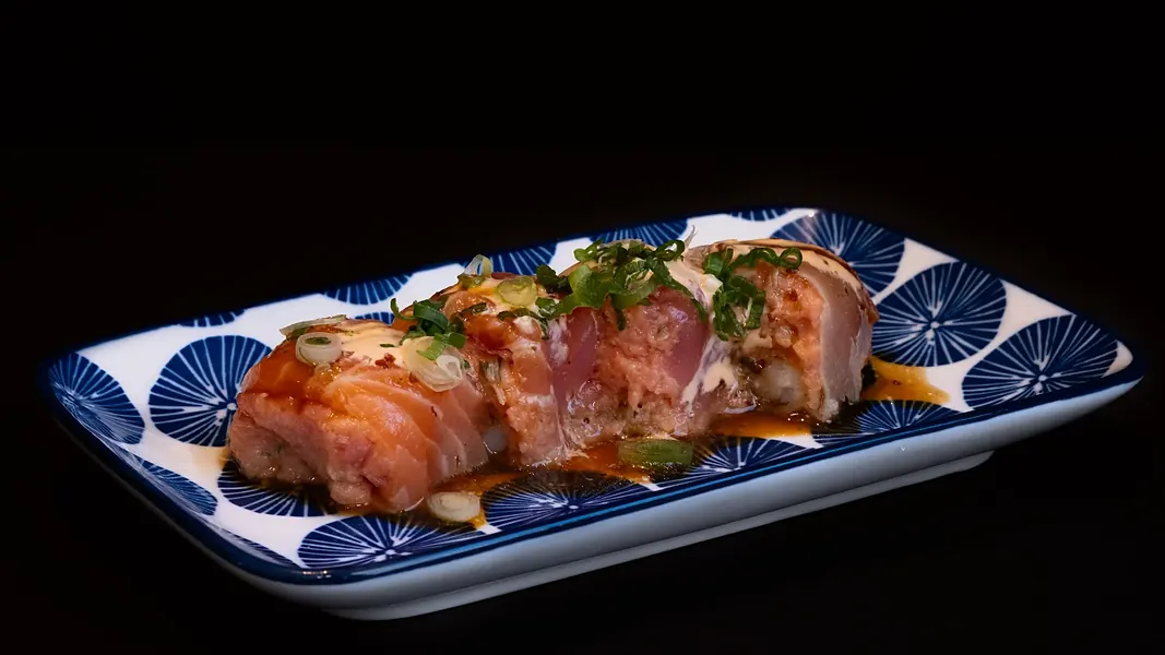 A seared roll on a blue plate