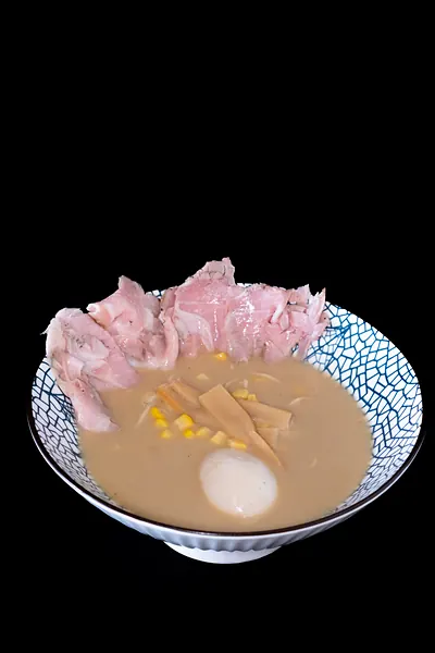 A bowl of ramen with corn