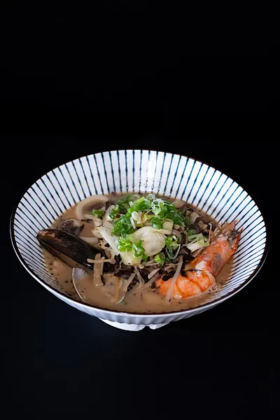 A bowl of noodle soup with shrimp