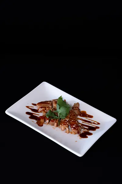 A grilled plate with sauce