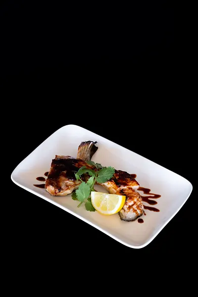 A grilled plate with lemon