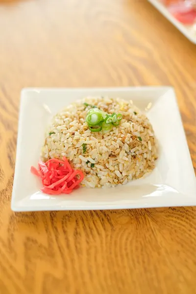A plate of rice with pickled ginger